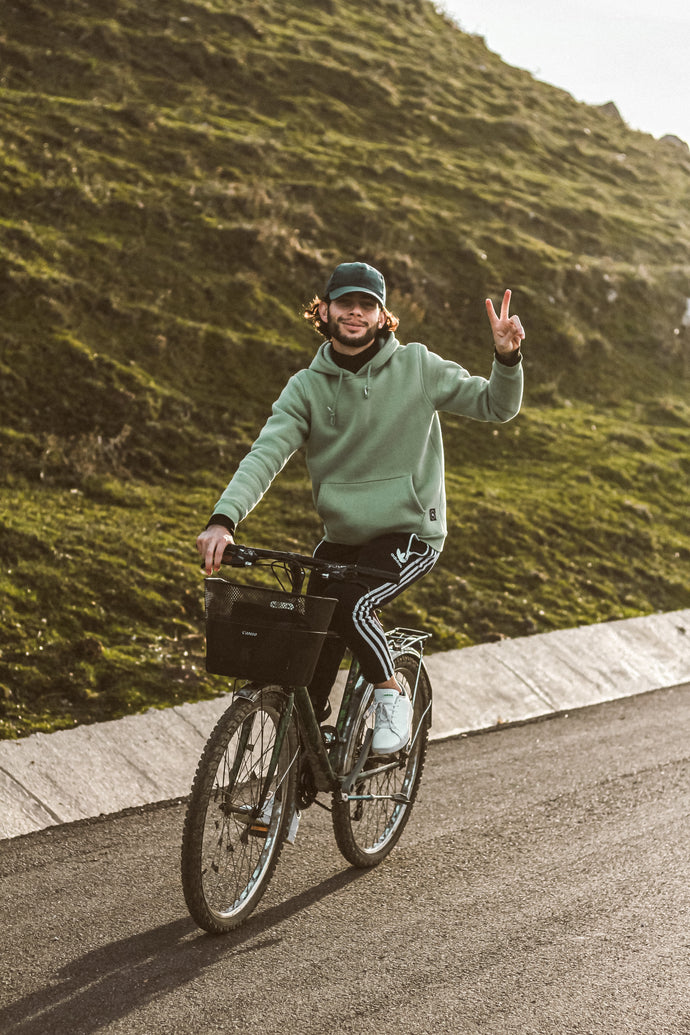 man riding a bike showing peace sign