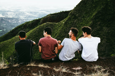 Four men having fun looking out over a mountain