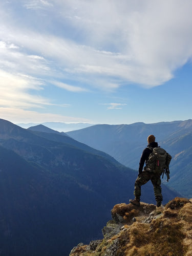 person on a mountain representing NO SYNTHETIC FRAGRANCE